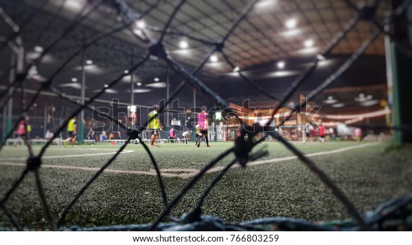 Blurred and selective focus of indoor soccer field\
on holiday at night\
time