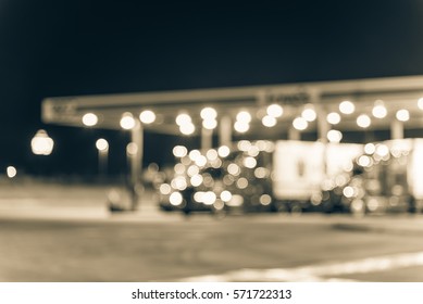 Blurred Several Large Over Road Semi-trucks At Fueling Station Truck Stop, Ozark, Arkansas. Defocused Gas Station, Convenience Store. Transportation, Industrial Background Bokeh Light. Vintage Tone.