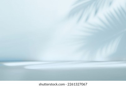 Blurred shadow from palm leaves on the light blue wall. Minimal abstract background for product presentation. Spring and summer. - Shutterstock ID 2261327067