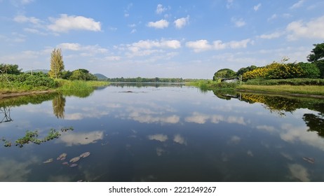 Blurred Shadows Of The Sky On The Still Water Surface.