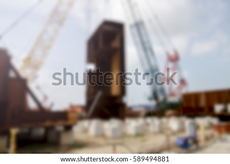 Blurred ship construction site with people and machineries.