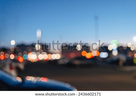 blurred shopping mall parking lot background with lights and cars, Shopping mall outdoor parking lot and bokeh light of retail store in background