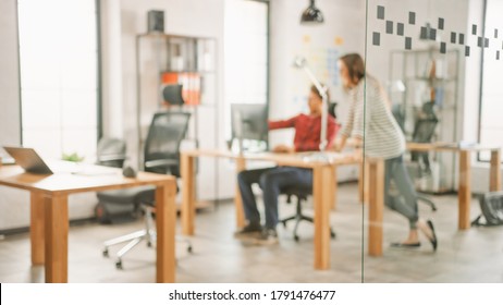 Blurred Shot Of Creative Agency Life. Female Colleague With Coworker Talk About Business Opportunities. Creative Office Concept.