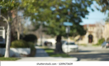 Blurred Shot Of A Typical Street Sign And Trees In Suburban Neighborhood