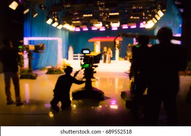 Blurred Silhouette Cameraman With  Staff In TV Studio Station