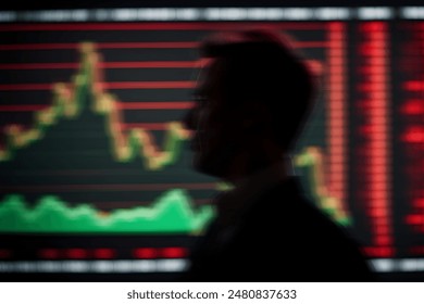 A blurred silhouette of a person is seen in the foreground with a background of a stock market chart displaying a fluctuating trend line in red and green. - Powered by Shutterstock - Get 15% off with code: PIKWIZARD15