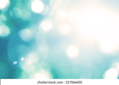 Blurred Sky Background With Nature Glowing Sun Light Flare And Bokeh In Spring Green Cyan Foliage