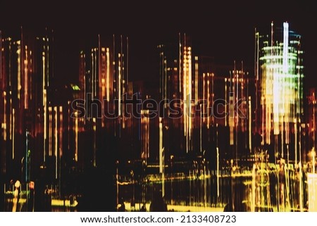 Blurred skyscrapers against dark sky, buildings at night, Illuminated windows. Modern neon city