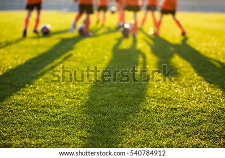 Blurred Soccer Field at School. Young Soccer Players Training on Pitch. Soccer Stadium Grass Background