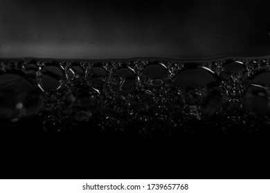 Blurred In Soft Focus Black Background With Oil Surface And Bubbles.