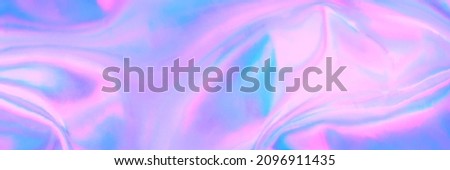 Blurred soft focused abstract trendy rainbow holographic banner background in 80s style. Textile texture in purple, violet, pink and mint soft pastel colors. Trendy ethereal candy colors backdrop.