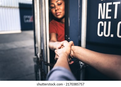 Blurred soft images of A person holding and helping to pull a several woman's hand which is inside a container, to human trafficking and illegal immigration concept.