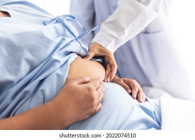 Blurred soft images of woman doctor using a hand to hold the belly fat Of obese woman patients, who received treatment for diabetes Caused by obesity, This picture focused on doctor's hand