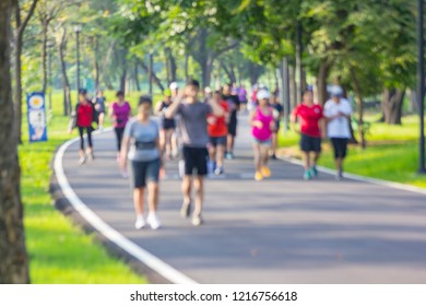 Blurred Soft Of People Jogging In The Park. / Blur Of Runners Jogging In Park Early Morning. / Marathon Runners In The Park Background. / Exercise Makes Healthy.