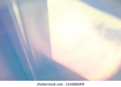 blurred soft rainbow light flares background or overlay. double exposure. blurry reflection of the sky in the window