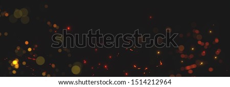 blurred sparks from fire in front of black backgound