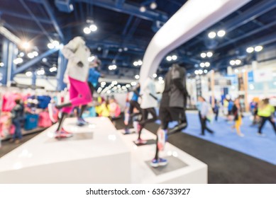 Blurred Sports And Fitness Clothing Merchandise Store In Conventional Hall/expo Event Fair In US. Active Wear Shop, Famous Fashion Brand Worldwide Of Athletic Shoes, Gear And Apparel With Mannequins