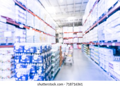 Blurred Stack Of Paper Product (napkins, Towels) And Bottled Water Floor To Ceiling In Large Warehouse. Wholesale Big Box Store In USA, Shopping Cart. Defocused Distribution Storehouse. Vintage Tone