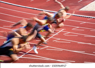 blurred start of athletic runners in sprint