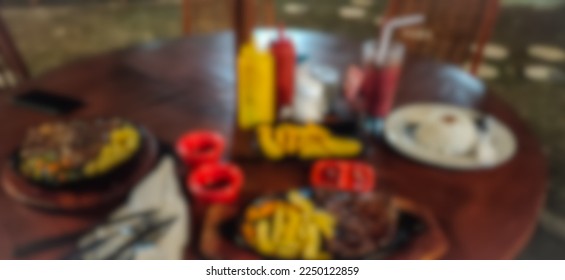 blurred steak dinner on the table