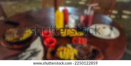blurred steak dinner on the table