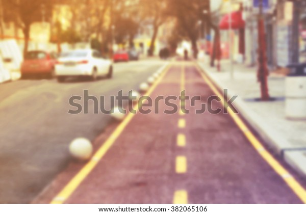 Blurred street with bike
line, people, cars and blurred lights. Blurred street background /
texture.