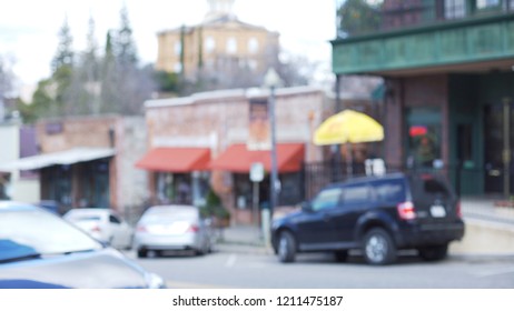 Blurred street view of main city street in Auburn, California, a small historical mining town. Out of focus background plate of downtown street filled with shops and cars. 4k