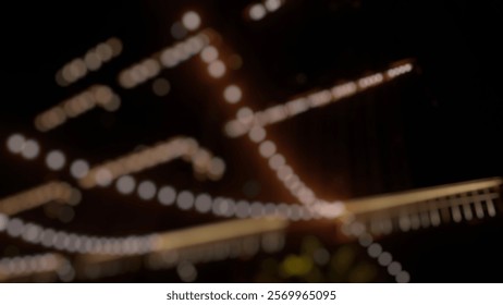 Blurred String Lights Decorating a Night-Time Urban Environment with a Festive Atmosphere