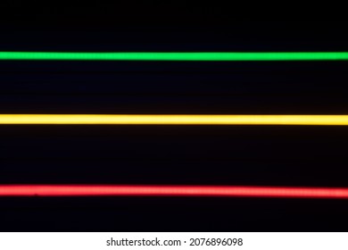 Blurred Stripes Of Neon Lights. Green, Yellow And Red Colors. Rastafarian Background..