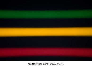 Blurred Stripes Of Neon Lights. Green, Yellow And Red Colors. Rastafarian Background..