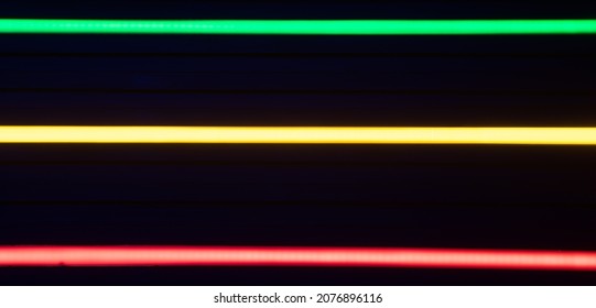 Blurred Stripes Of Neon Lights. Green, Yellow And Red Colors. Rastafarian Background..