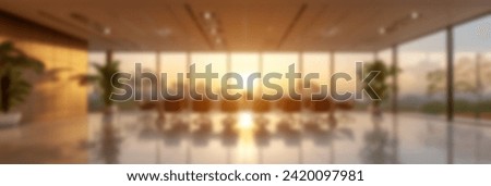 Blurred Sunset view through the large windows of a modern office, creating a warm and inviting atmosphere, ideal for corporate backgrounds