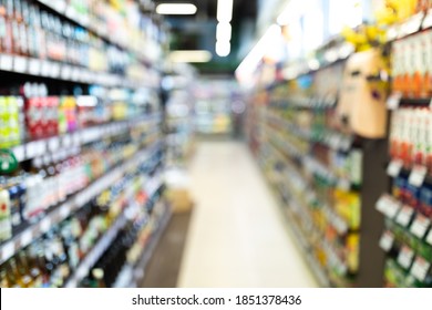 Blurred Supermarket Aisle Background, Grocery Store Defocused Shot With Blurry Colorful Shelves And Unrecognizable Food Products. Groceries Shopping, Shop Warehouse Concept, No People