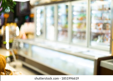 Blurred Supermarket Aisle Background With Refrigerators And Food Products On Shelves In Grocery Store. Abstract Defocused Shot, Groceries Shopping Concept, No People