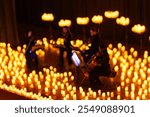 blurred symphonic orchestra on stage with lots of candles for design purpose