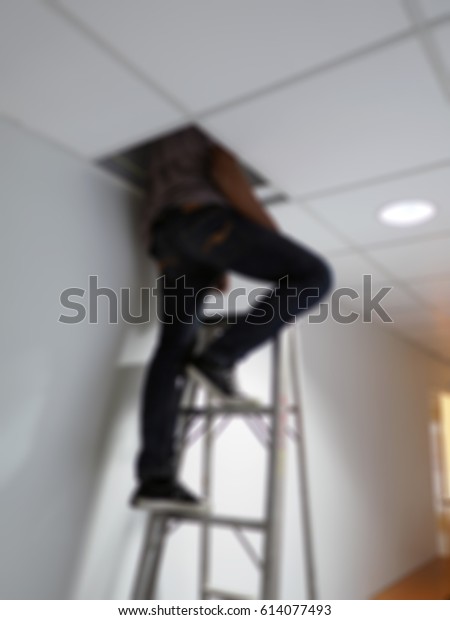 Blurred Technician Install Suspended Ceiling Office