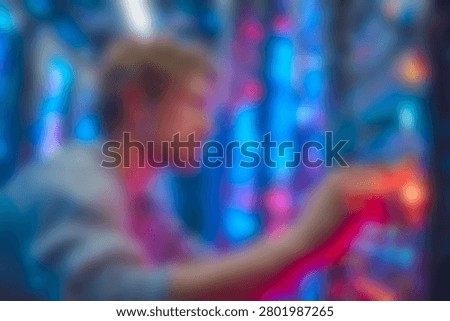 Blurred It technician working on server hardware in a hightech data center