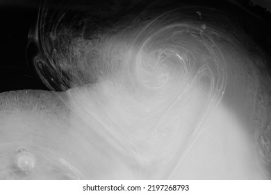 Blurred Texture Of White Liquid Paint On A Black Background. Monochrome Background For The Design. Liquids Are Mixed And Dammed.
