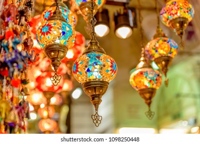 Blurred Traditional colorful handmade Turkish lamps and lanterns hanging in souvenir shop for sale