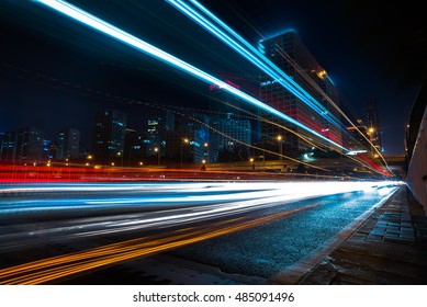 blurred traffic light trails on road at night in China. - Shutterstock ID 485091496