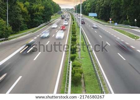 Blurred traffic on highway. High angle view of traffic on highway in sunset