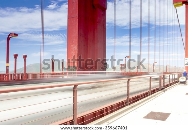 Blurred Trails of Cars and People Passing By\
on The Golden Gate Bridge in San-Francisco in the\
Afternoon.Horizontal Image\
Orientation