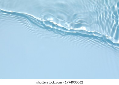 Blurred transparent blue colored clear calm water surface texture and splashes   bubbles  Trendy abstract nature background  Water waves in sunlight and copy space 