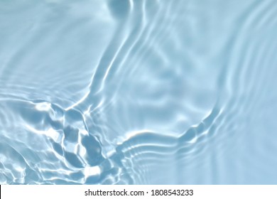 Blurred transparent blue colored clear calm water surface texture with splashes and bubbles. Trendy abstract nature background. Water waves in sunlight with copy space. - Shutterstock ID 1808543233