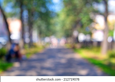 Blurred Unfocused City View At Day Time. Unfocused People In The Theme Park