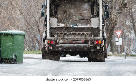 Blurred Unfocused Garbage Truck, Dustcart With Bin Lift, Household Waste Removal In Residential Area In Winter, Refuse Container, Snow, Film Grain Texture Added