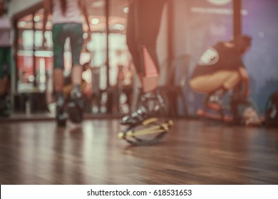 Blurred of an unidentified group of woman  doing exercises fitness with kangoo shoes in glass fitness studio.The best background for use.Cross processing and Split tone new colour trend like process.