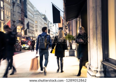 Blurred upmarket shopping street scene