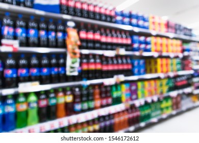 Blurred Variety Of Soft Drinks On Shelves At Grocery Store Supermarket. Blurred Effect Display Background, Drink Section.