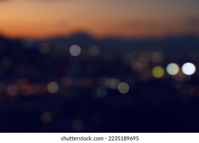 Blurred view of beautiful sunset with mountains in city, bokeh effect - Powered by Shutterstock